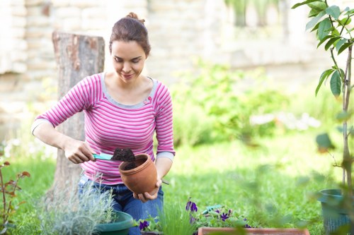 Professional gardener pruning plants in Brompton